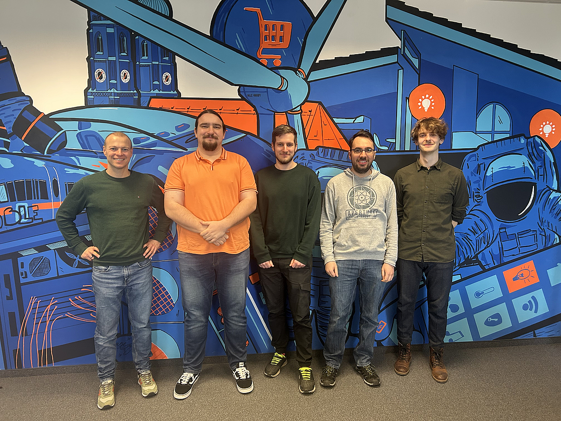 5 people in front of a colorful wall