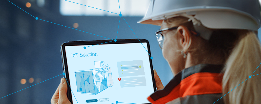 Key visual IoT: Woman looking at a tablet with connected machines