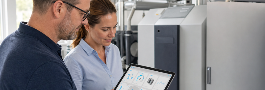 Two people use a digital solution to monitor a combined heat and power unit. – AI-generated image
