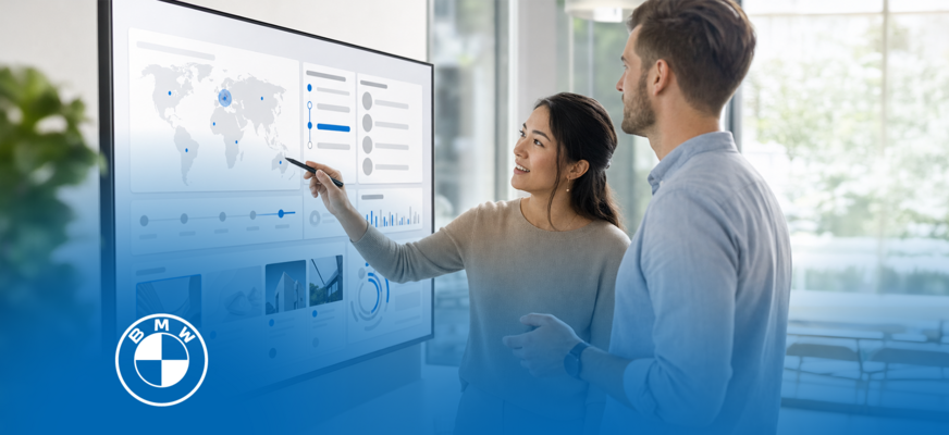 Two people analyzing a digital BMW sales and marketing dashboard. – AI-generated image