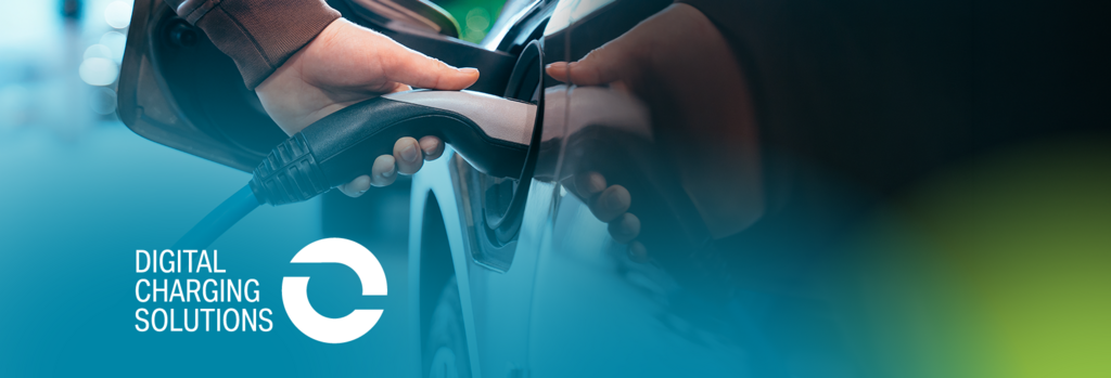 A person is plugging a charging cable into an electric car; blurred vehicles are visible in the background. In the bottom left corner, the text “Digital Charging Solutions” appears alongside a logo on a blue-green gradient background.