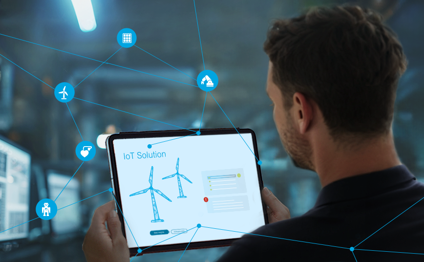 Keyvisual IoT: Man looking at a tablet with networked wind turbines