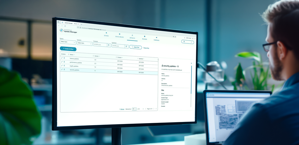 Person working at a desktop computer with a large monitor showing an update management interface.
