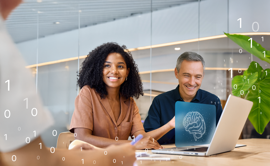 Two people are sitting together at a laptop in a modern office. A laptop is positioned in front of them. Above the laptop, a screen image with a brain graphic appears to be floating. Additional zeros and ones are dispersed throughout the scene.