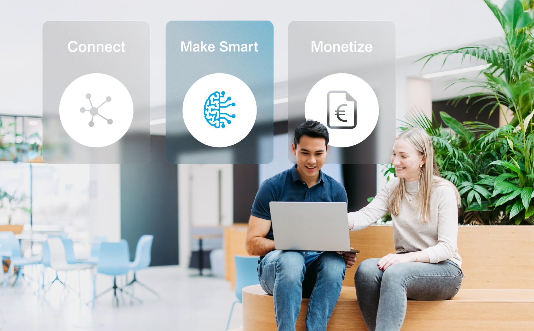 Two employees with laptops in a bright office environment; above them, the four service areas “Individual Solutions,” “Connect,” “Make Smart,” and ‘Monetize’ are displayed as visual navigation tiles. “Make Smart” is highlighted.